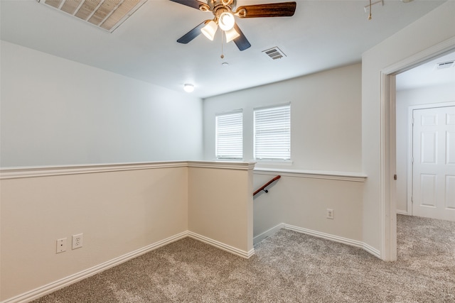 unfurnished room featuring light carpet and ceiling fan