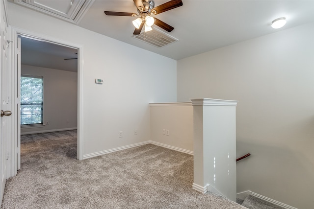 spare room with light carpet and ceiling fan