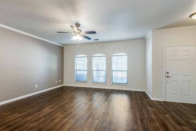 spare room featuring dark wood-type flooring, crown molding, and ceiling fan