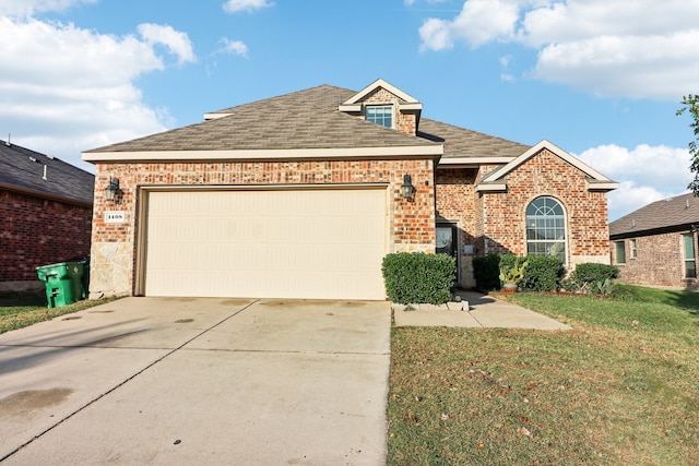 view of front property with a front yard and a garage