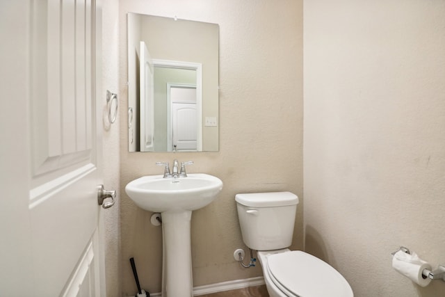 bathroom with toilet and sink