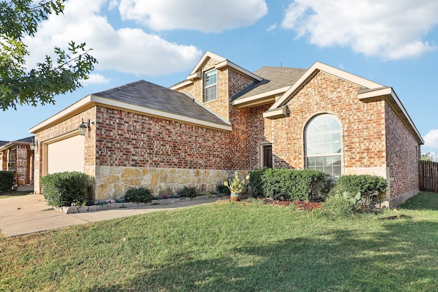 view of front of home with a front yard and a garage