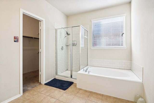 bathroom with independent shower and bath and tile patterned floors