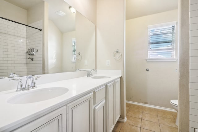 bathroom with vanity, toilet, plenty of natural light, and tile patterned flooring