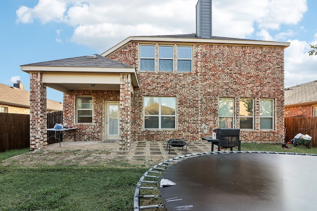 rear view of house featuring a yard and a patio