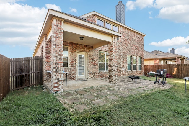 back of property featuring a patio area and a yard