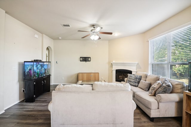 living room with dark wood-type flooring and ceiling fan