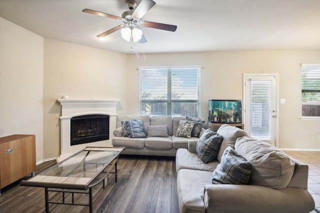 living room featuring ceiling fan and dark hardwood / wood-style flooring