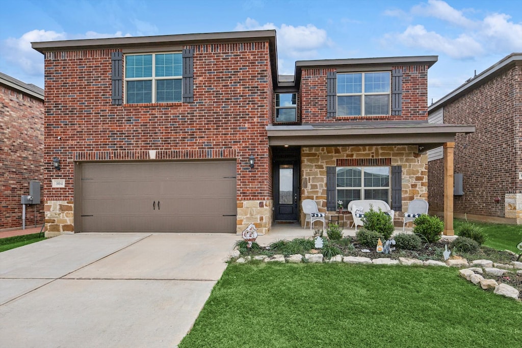 view of front of property featuring a front yard and a garage