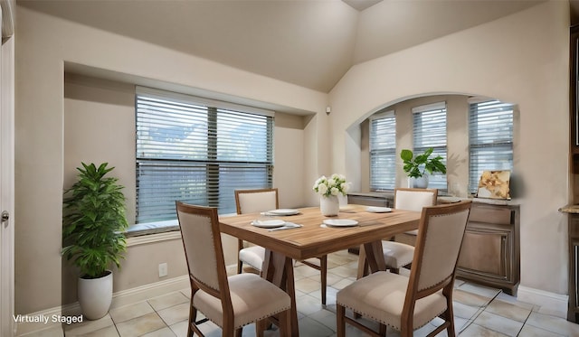 3123 Pamplona, Grand Prairie, TX 75054 - dining room featuring vaulted ceiling, light tile patterned floors, and baseboards
