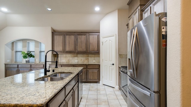 3123 Pamplona, Grand Prairie, TX 75054 - kitchen featuring stainless steel appliances, a sink, a center island with sink, recessed lighting, and light stone countertops