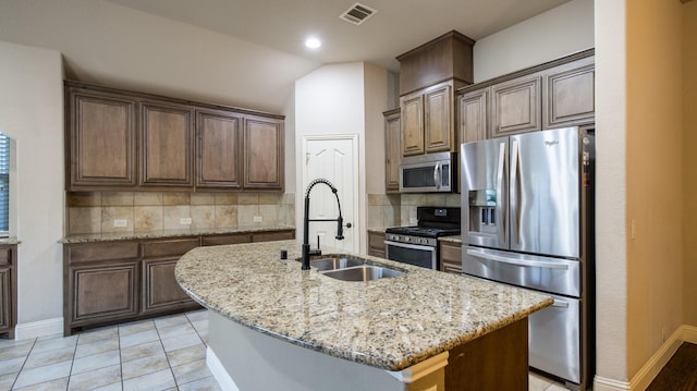 3123 Pamplona, Grand Prairie, TX 75054 - kitchen with appliances with stainless steel finishes, a sink, tasteful backsplash, light stone counters, and vaulted ceiling