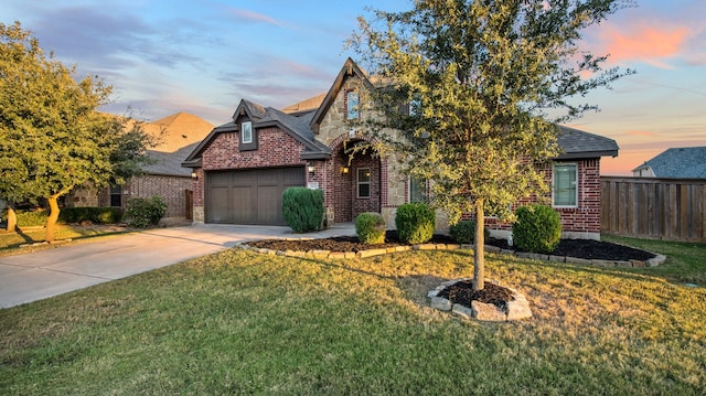 view of front of house featuring a yard and a garage