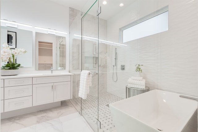 bathroom featuring vanity, tile walls, and plus walk in shower