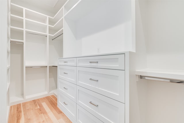 walk in closet featuring light hardwood / wood-style flooring