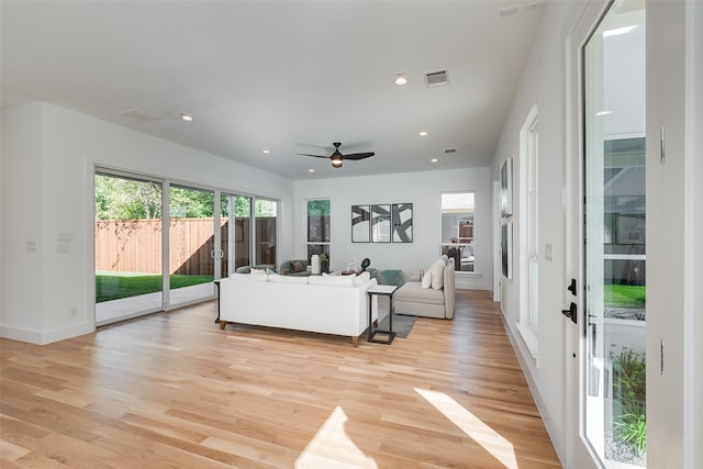 living room featuring light wood-type flooring and ceiling fan