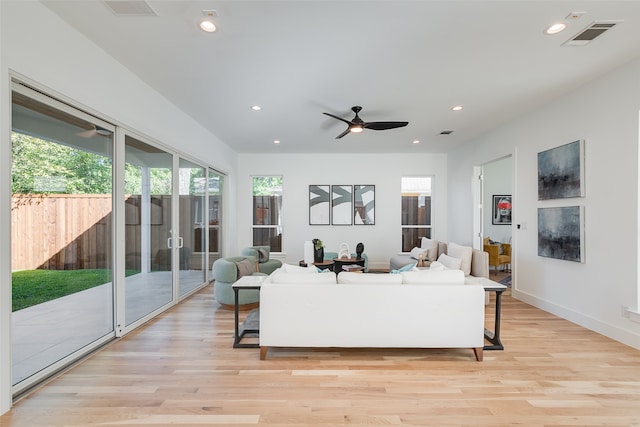 living room featuring light hardwood / wood-style floors and ceiling fan