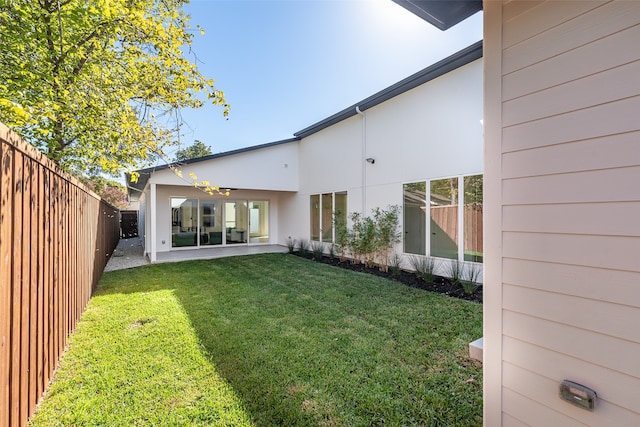 back of property featuring a patio area and a lawn