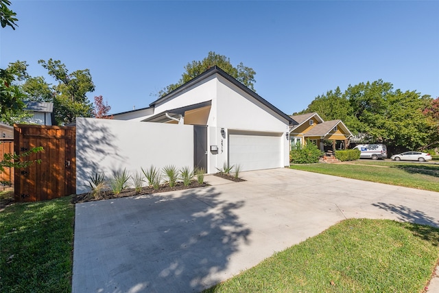 view of front of home with a front yard and a garage