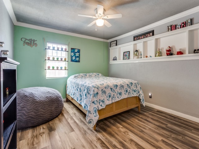 bedroom featuring crown molding, a textured ceiling, wood-type flooring, and ceiling fan