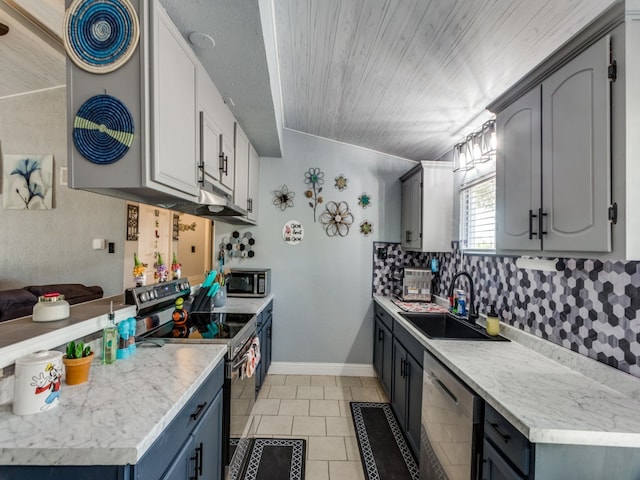 kitchen featuring sink, appliances with stainless steel finishes, gray cabinetry, and light tile patterned floors