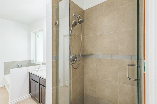 bathroom featuring a shower with door, vanity, and tile patterned floors