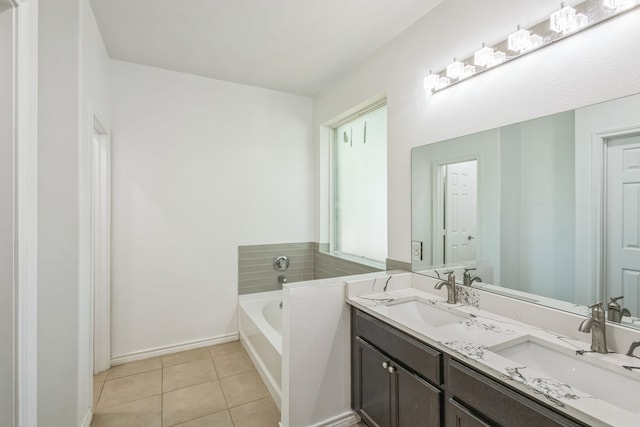 bathroom featuring vanity, a tub, and tile patterned flooring