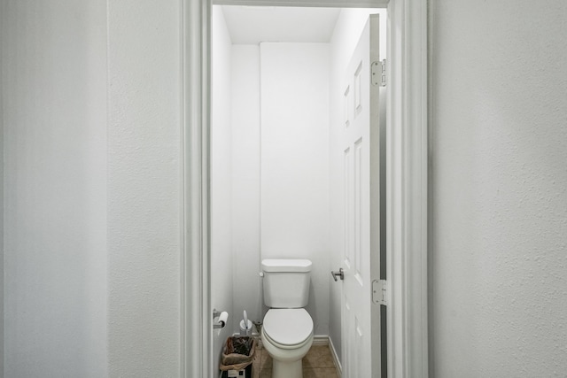 bathroom featuring toilet and tile patterned flooring