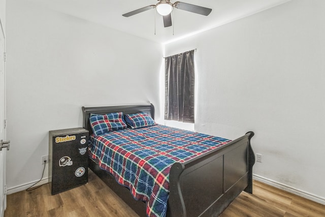 bedroom with ceiling fan and hardwood / wood-style flooring