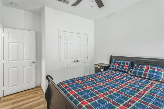 bedroom with hardwood / wood-style floors, a closet, and ceiling fan