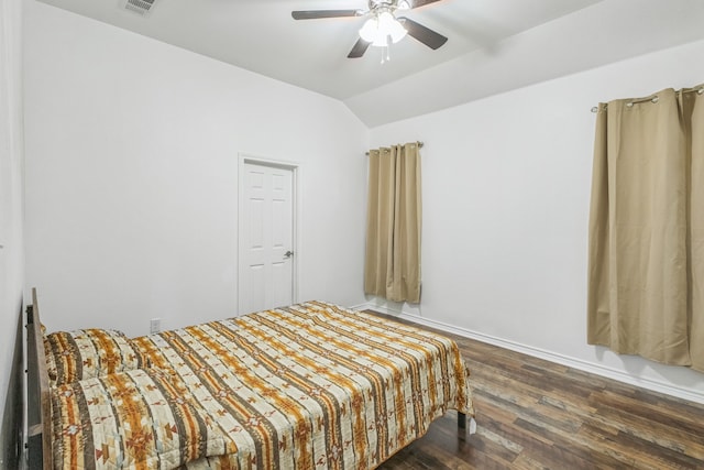 bedroom with dark wood-type flooring, vaulted ceiling, and ceiling fan