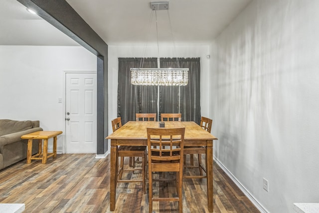 dining space with a chandelier and dark hardwood / wood-style floors