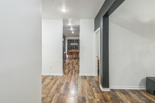 hall with dark hardwood / wood-style flooring