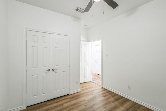 unfurnished bedroom with a closet, ceiling fan, and hardwood / wood-style floors