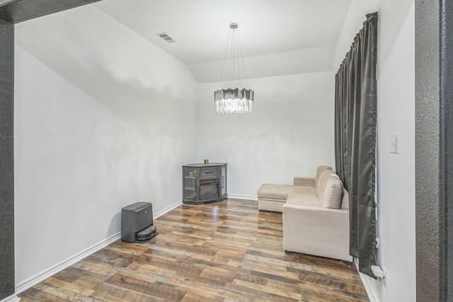 living area with hardwood / wood-style floors and vaulted ceiling