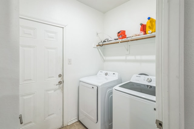 clothes washing area featuring separate washer and dryer