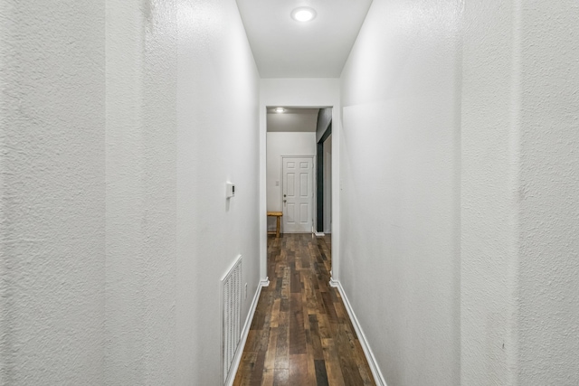 hall with dark wood-type flooring