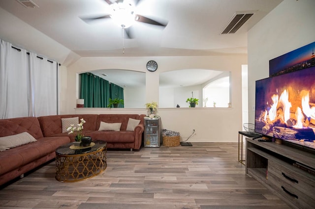 living room featuring wood-type flooring and ceiling fan