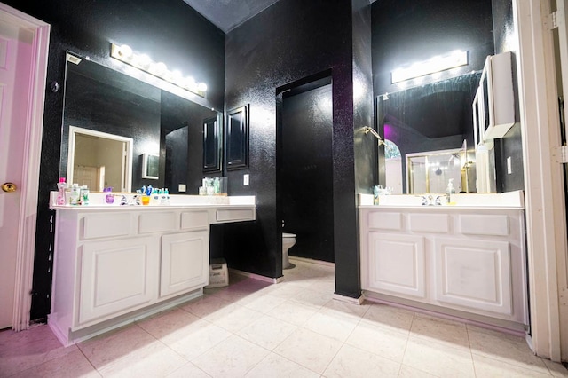 bathroom with vanity, toilet, and tile patterned floors