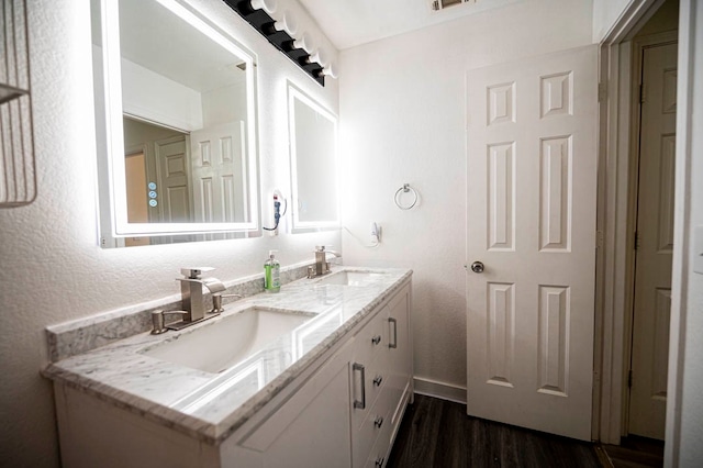 bathroom with vanity and hardwood / wood-style flooring