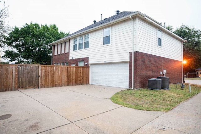 view of property exterior with a garage and central air condition unit