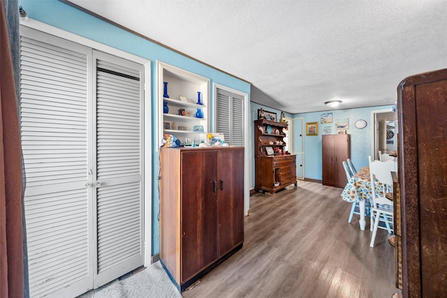 kitchen featuring a textured ceiling and wood-type flooring