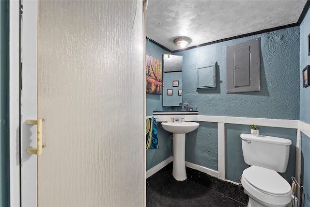 bathroom featuring ornamental molding, a textured ceiling, and toilet