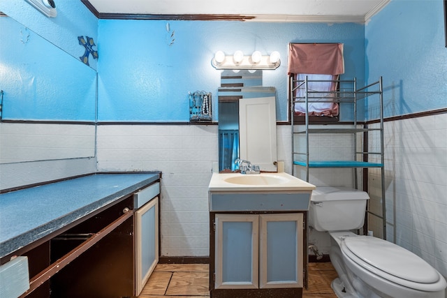 bathroom featuring vanity, toilet, and tile walls