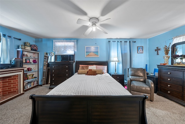 bedroom featuring cooling unit, light colored carpet, and ceiling fan