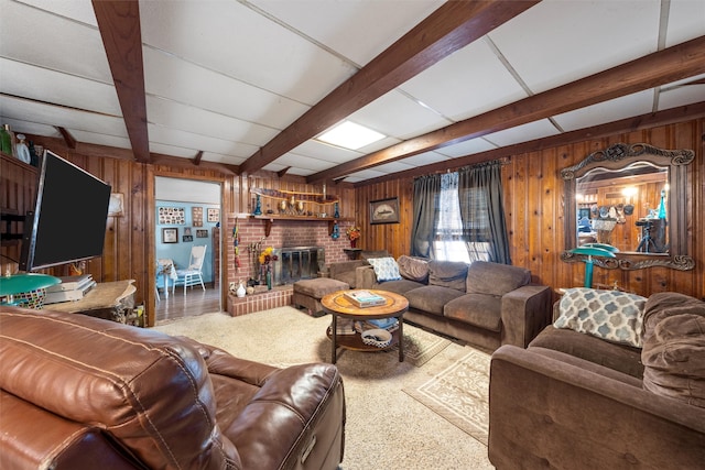 living room with beam ceiling, a brick fireplace, and wooden walls