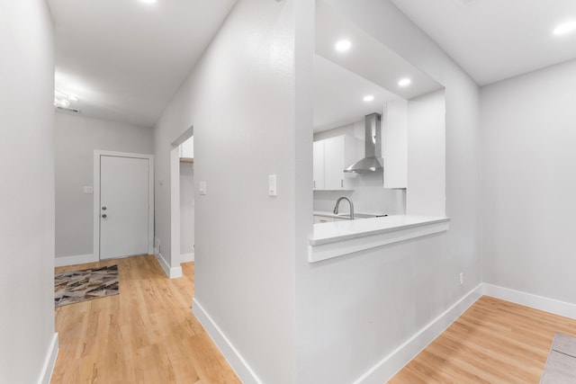 hall featuring sink and light hardwood / wood-style floors