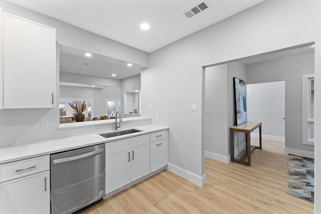 kitchen featuring white cabinetry, sink, tasteful backsplash, and stainless steel dishwasher