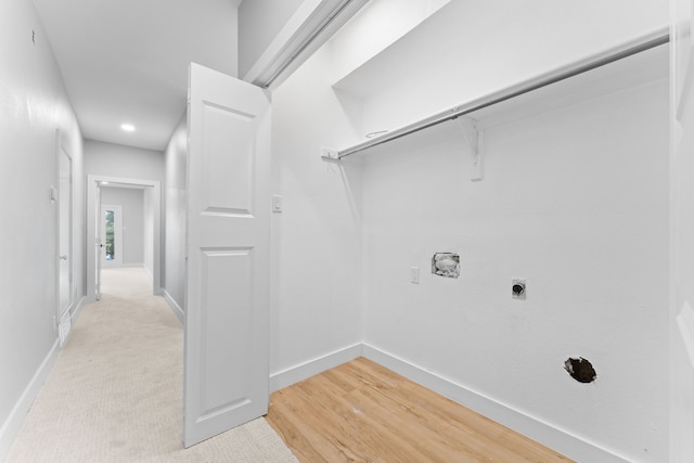 washroom featuring electric dryer hookup and light wood-type flooring