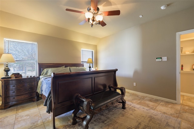 bedroom with multiple windows and ceiling fan